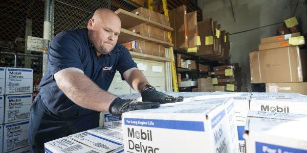 Flyers employee unloading Mobil Delvac product in warehouse