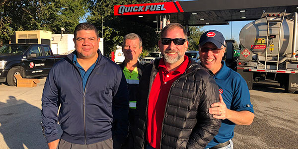 Quick Fuel team members in front of Quick Fuel Cardlock site. 