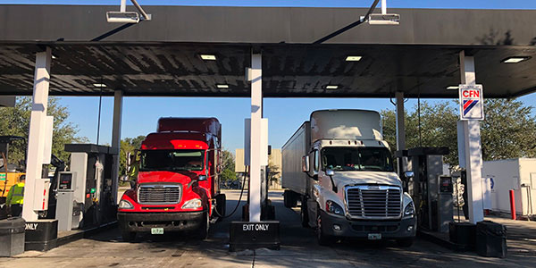 Cardlock site showcasing two commercial trucks in RFID bays