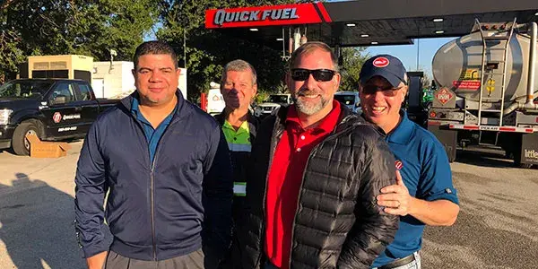 Quick Fuel team members in front of Quick Fuel Cardlock site.